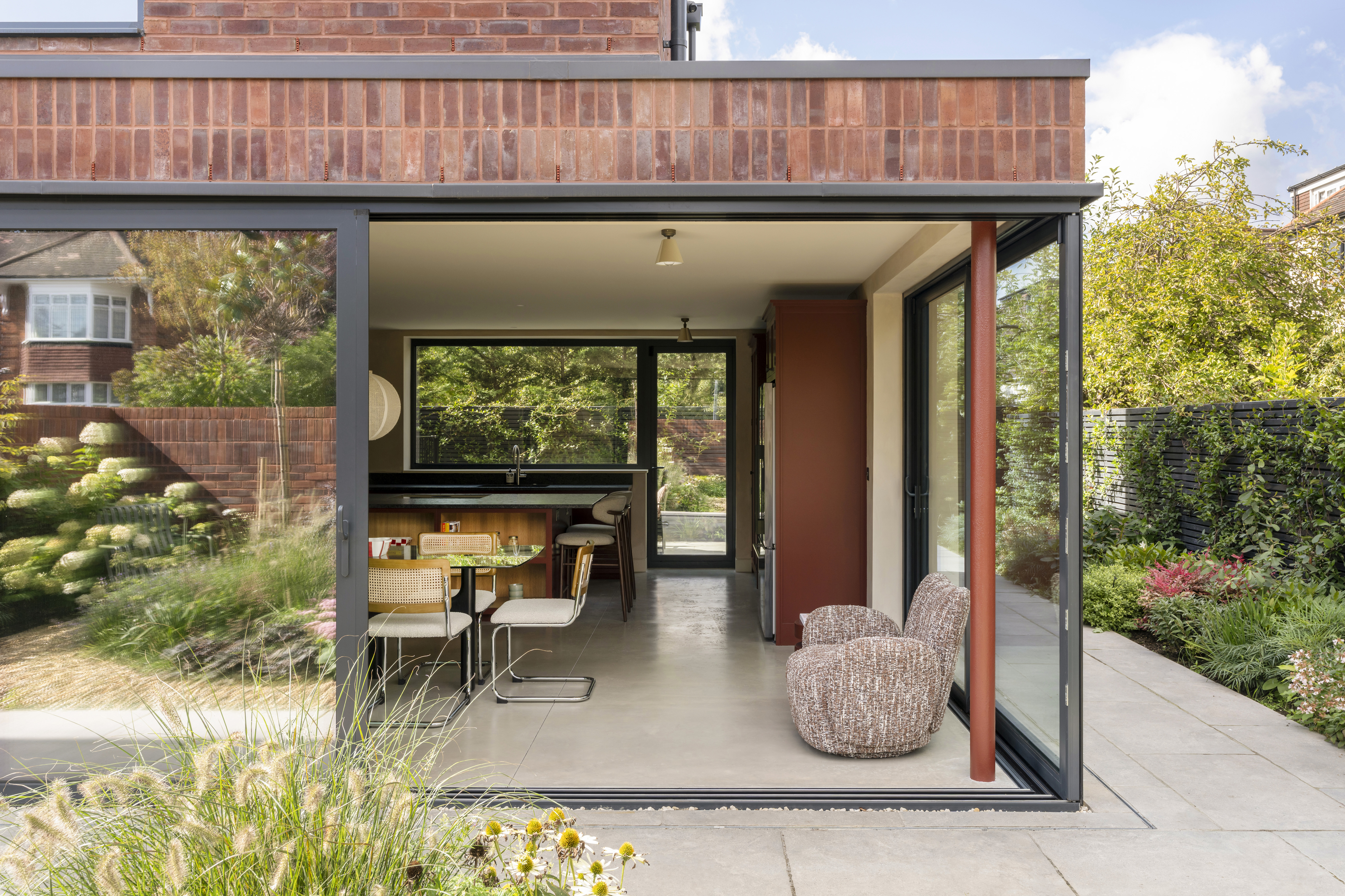 view of interiors of Coeus London - Serene, a brick residential structure with a lush garden