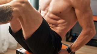 a man doing crunches on a chair 