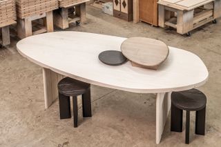 Sebastian Herkner’s bleached red oak table, with tracks to allow trays, seen here in scorched red oak and ammonia-fumed maple, to slide along it