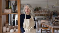 A female ceramicist posing in her studio