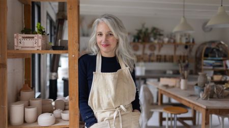 A female ceramicist posing in her studio