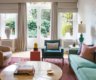 Green sofa, blue armchair, curtains, rug