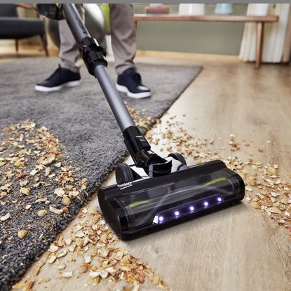 Beko cordless vacuum cleaner in use on a dirty floor
