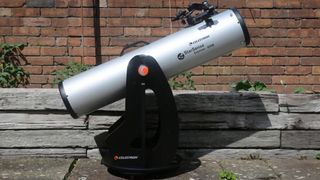 A Celestron StarSense Explorer 8-inch dobsonian outside on the pavement