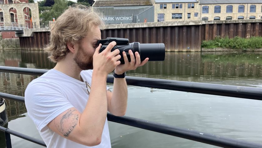 Nikon Coolpix P1100 lifestyle image of Mike Harris holding camera by river 