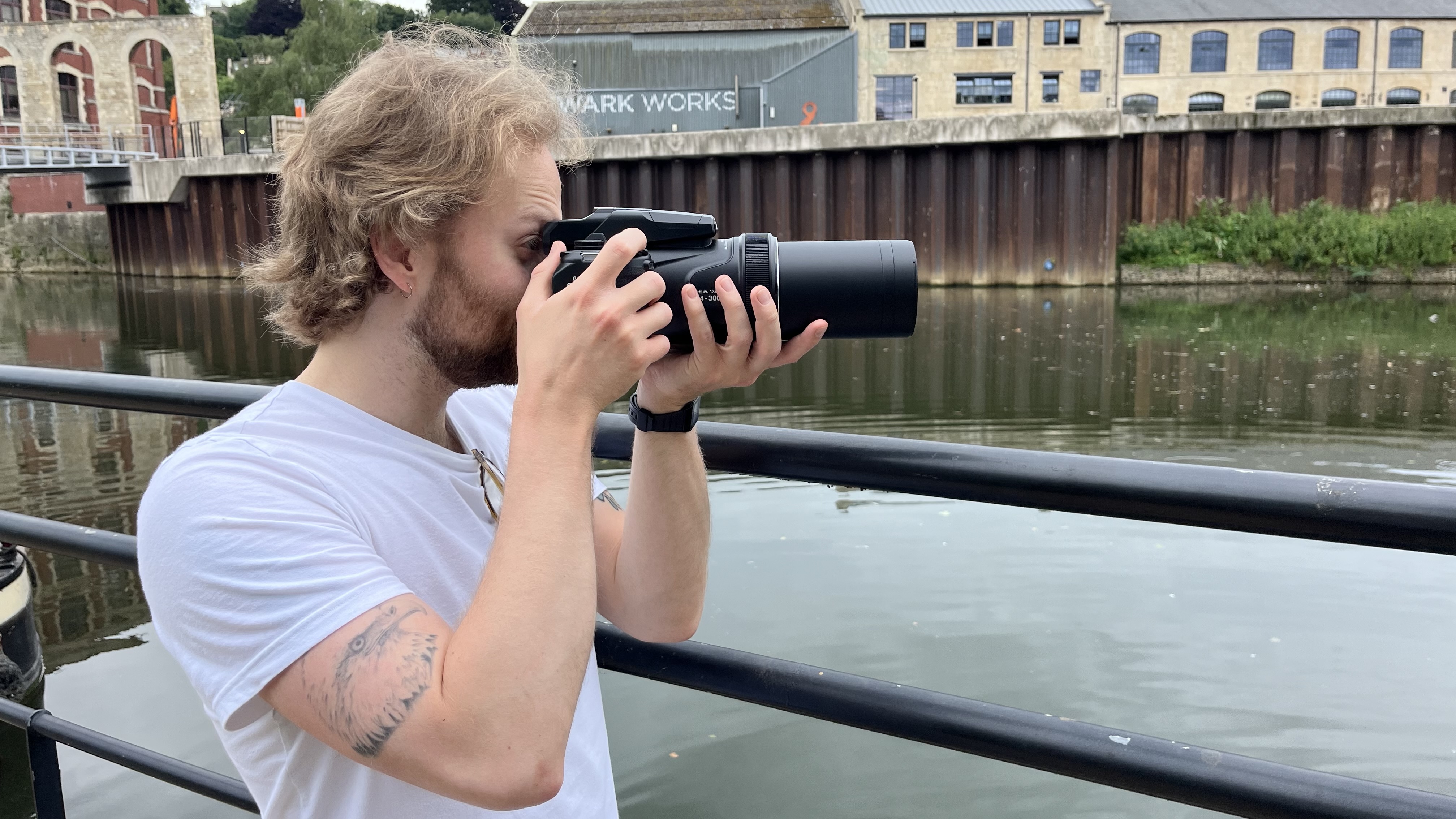 Nikon Coolpix P1100 lifestyle image of Mike Harris holding camera by river