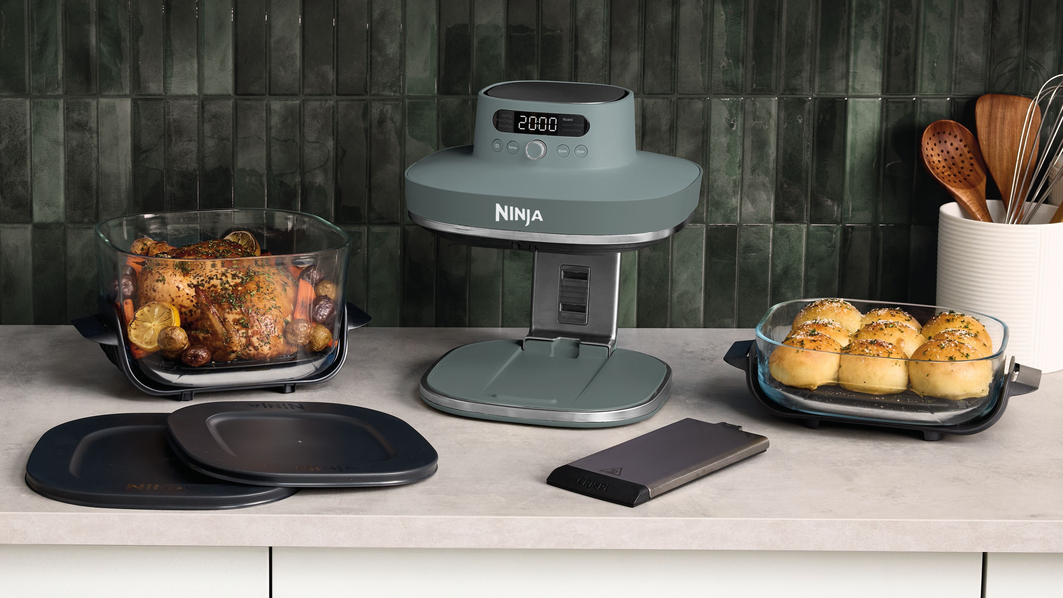 Ninja Crispi Pro air fryer with food and accessories on kitchen counter