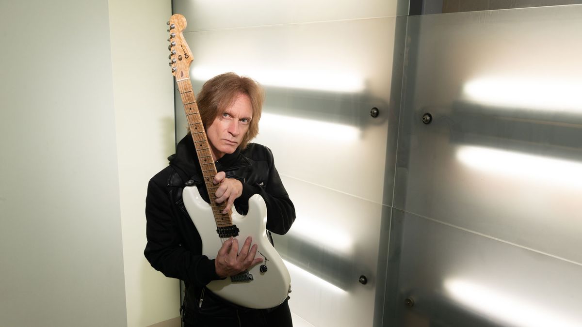 Chris Impellitteri poses with a Charvel electric guitar