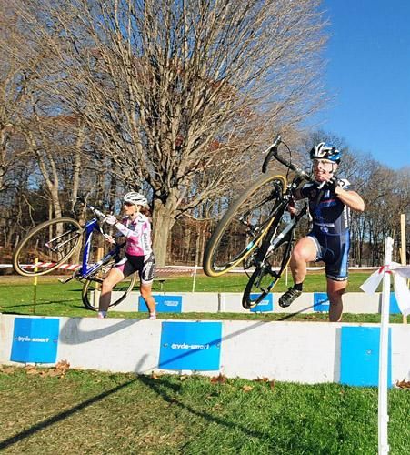 Laura Van Gilder (C3 Athletes Serving Athletes) leads Elliot over the barriers.