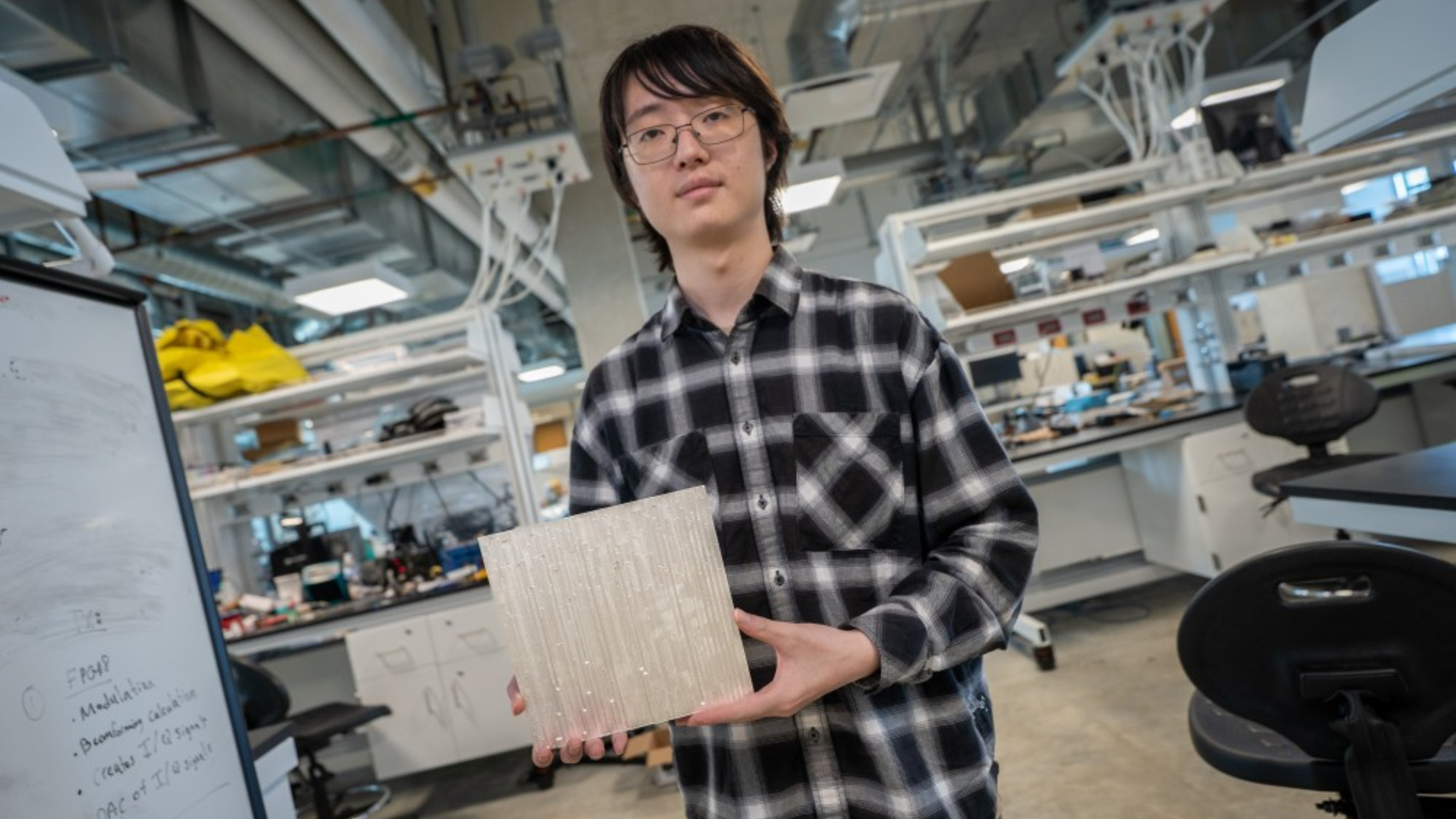 Student holding panel of 6G tiles.