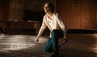 Dune Timothee Chalamet crouches with a blade in hand