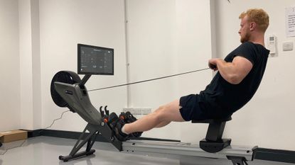 Our expert fitness reviewer testing the Aviron Tough Series Rower