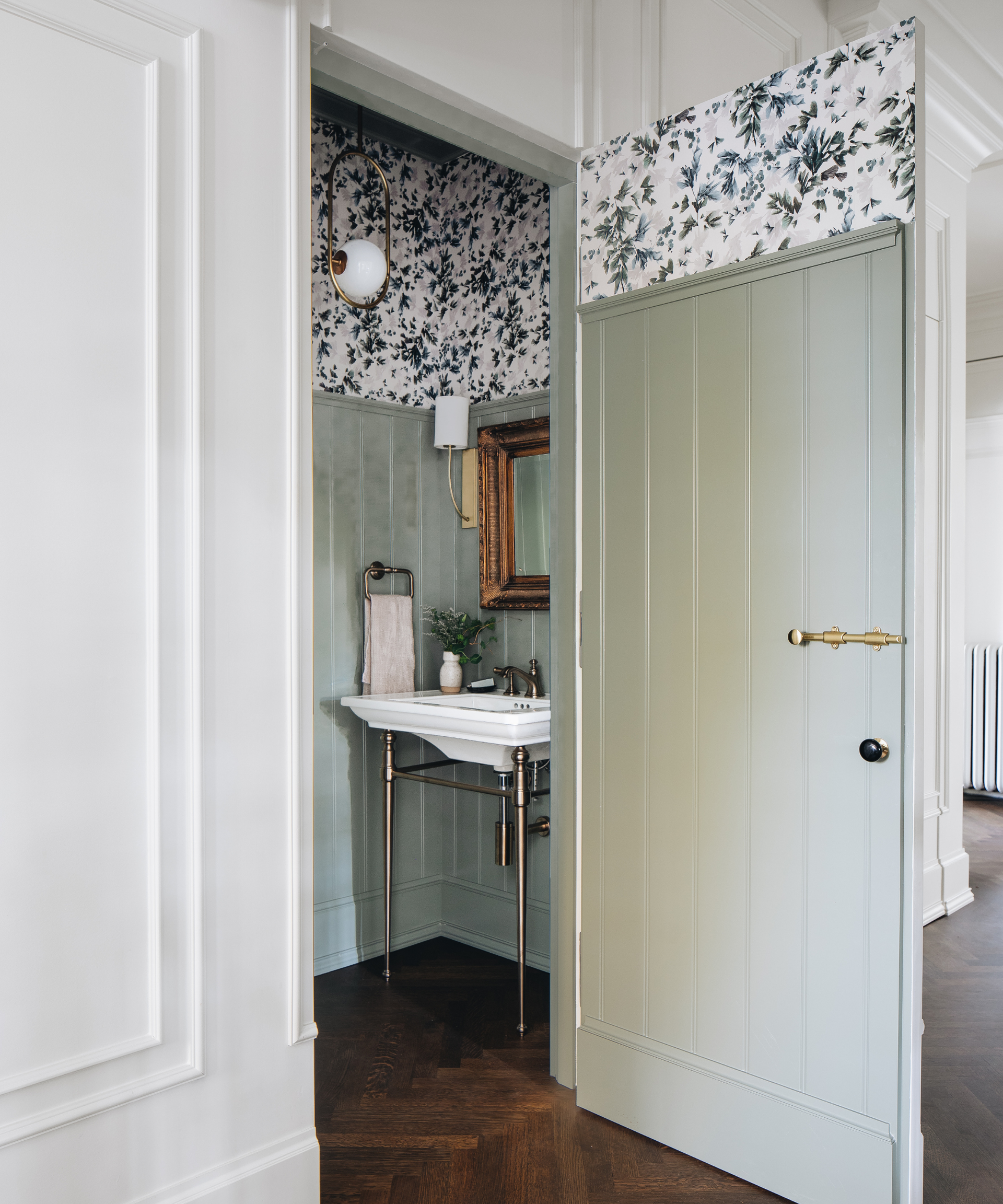 A light green doorway that opens to a bathroom decorated with the same color.