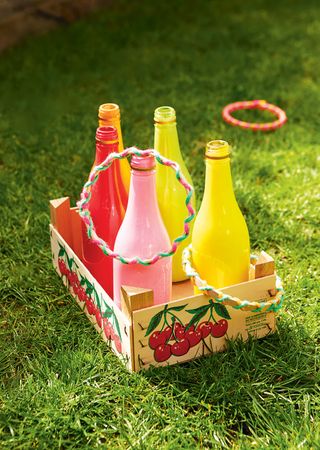 bottle game with brightly colored bottles and crate at party