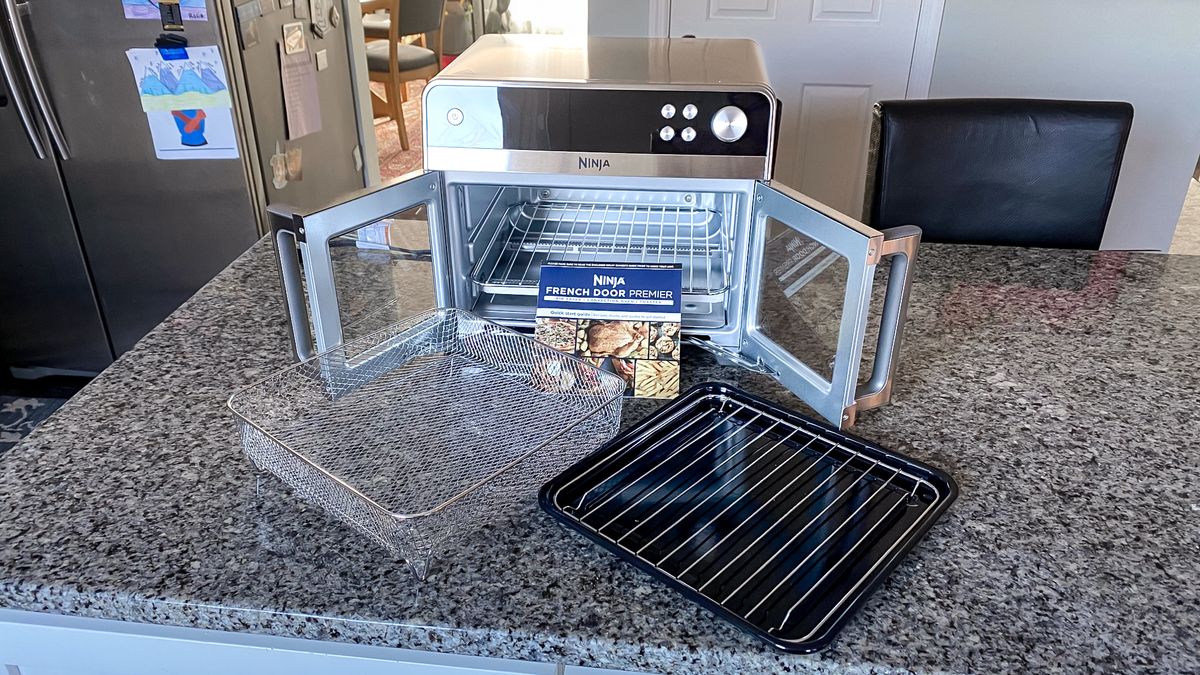 Ninja French Door Premier Air Fryer on a kitchen counter with doors open and accessories