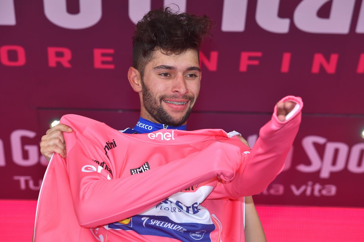 Fernando Gaviria can't hide his excitement as he pulls on his first pink jersey