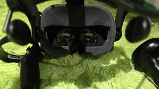 A Pimax Crystal Super virtual reality headset on a green background.
