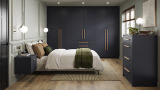 bedroom ideas with navy wardrobes, large bed with white bedding, wooden floor and window