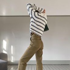 @smythsisters wears camel jeans with a striped jumper