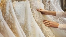 best wedding dress shapewear: Bride looking at wedding dresses