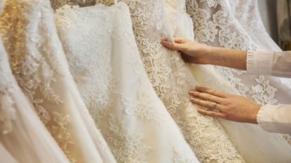 best wedding dress shapewear: Bride looking at wedding dresses