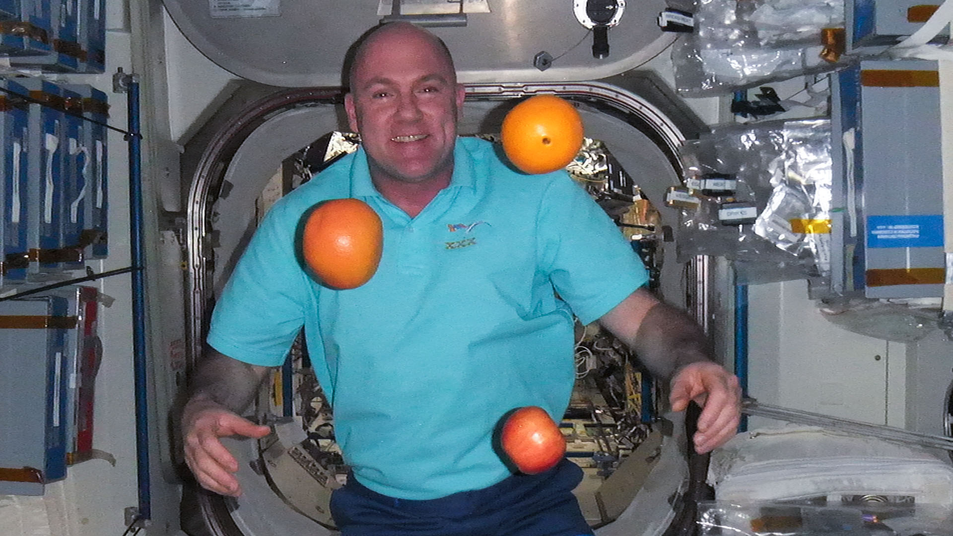 Astronaut and Oranges Float in Expedition 30 Spacecraft