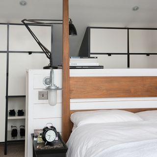 bedroom with wooden headboard and lamp