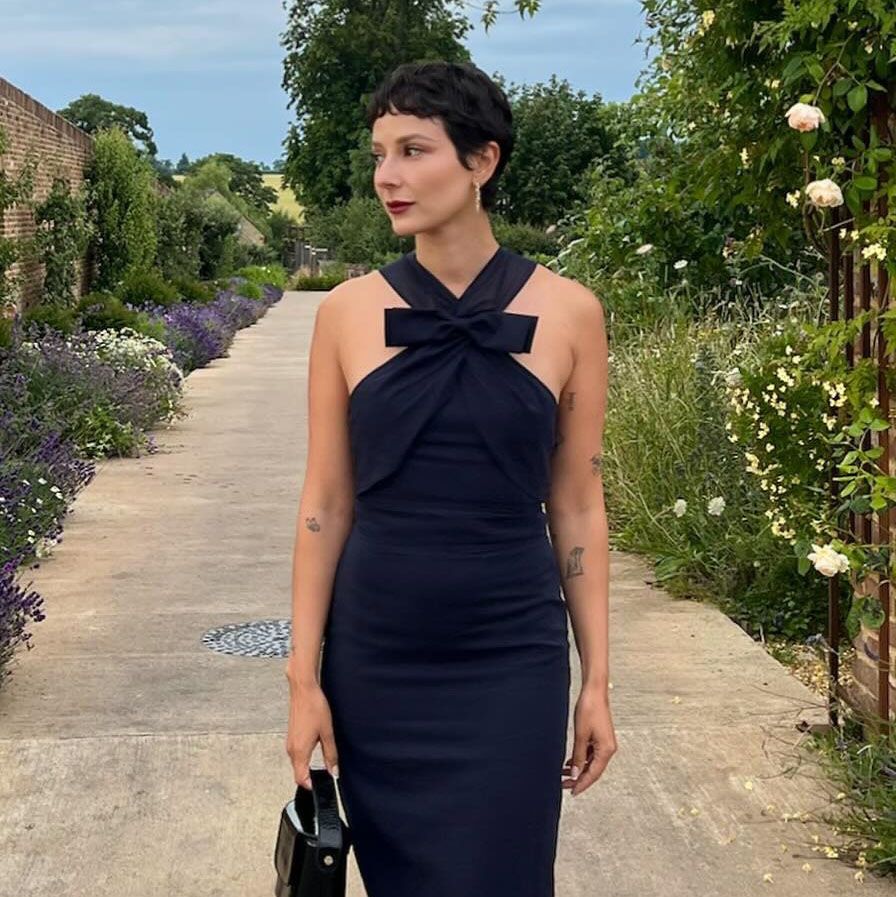 a woman wearing a black dress 