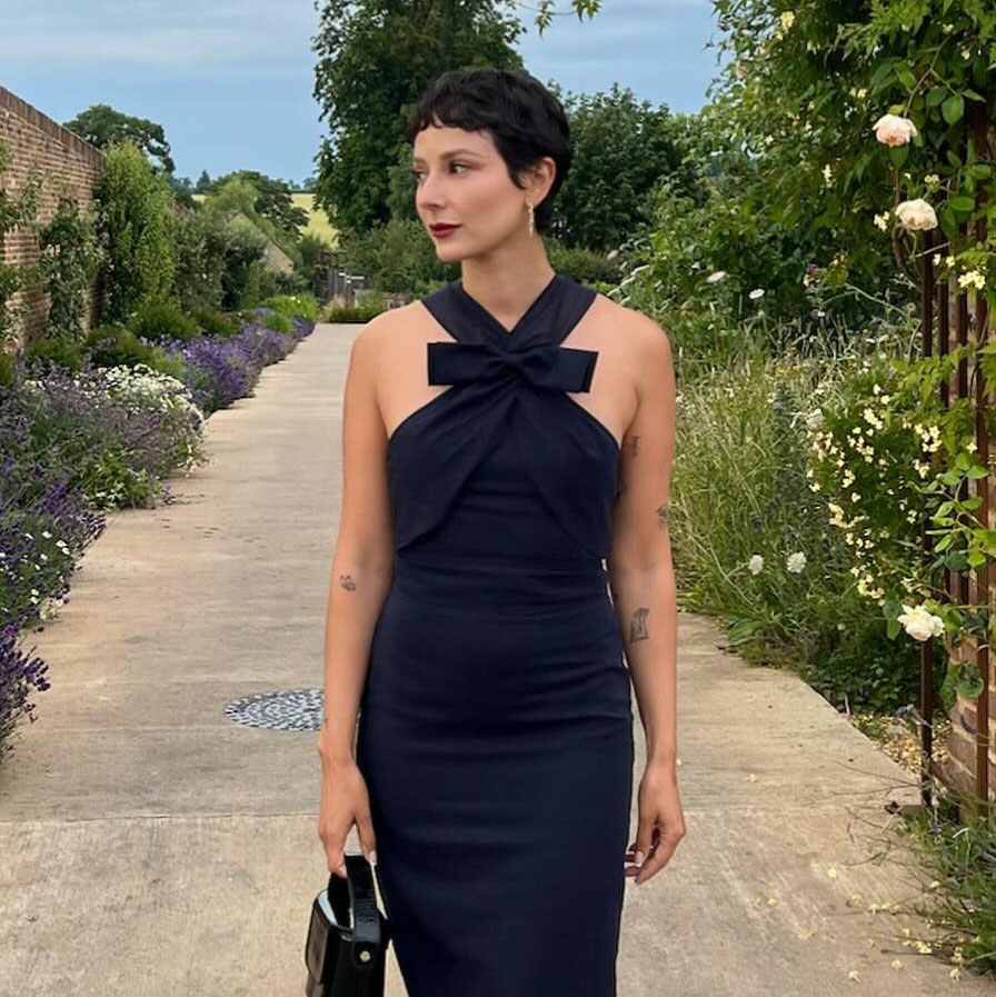 a woman wearing a black dress 