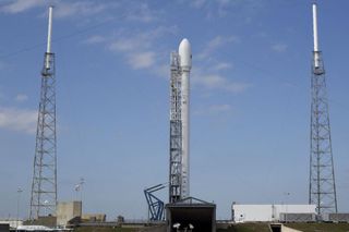 A SpaceX upgraded Falcon 9 rocket stands poised to launch the SES-8 communications satellite into orbt from Cape Canaveral Air Force Station in Florida during a Nov. 28, 2013 launch attempt, which was ultimately aborted due to a technical glitch.