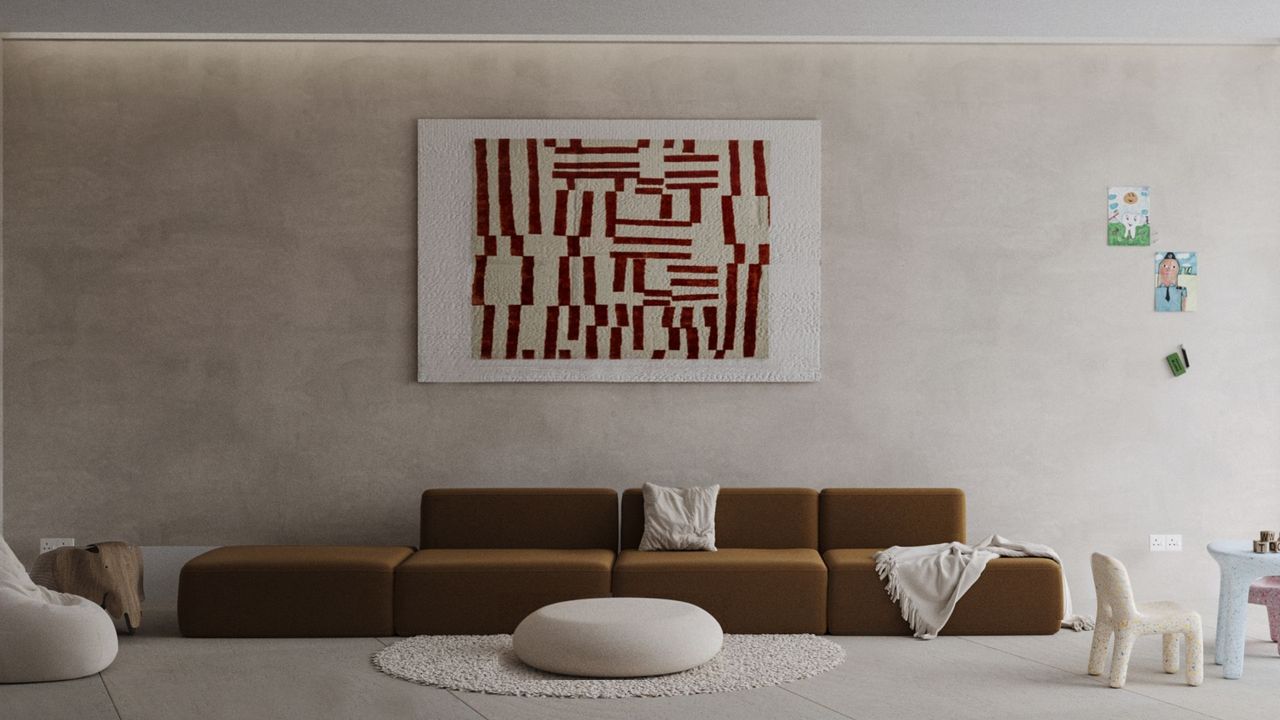 A clean living room with a sofa in the middle. Artwork also hangs on a wall