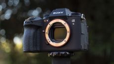 Sony A9 III camera outside with background foliage, no lens attached