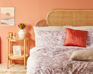 Peach and rattan bedroom with faux flowers by Primark