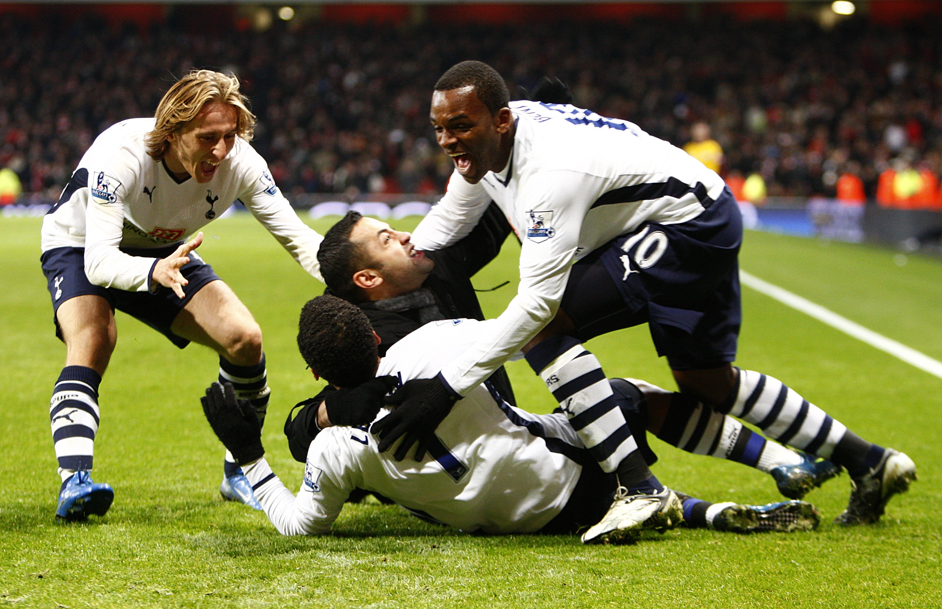 Tottenham celebrated a famous point against Arsenal under new boss Harry Redknapp thanks to a late leveller from Aaron Lennon.