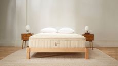 Two nightstands either side of the Birch Luxe Natural Mattress against a white wall.