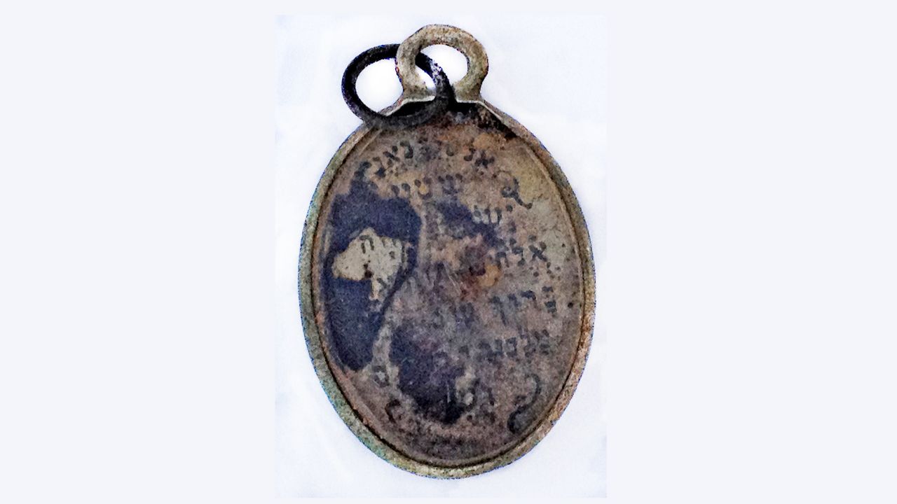 A pendant discovered in a women's undressing area at Sobibor, where victims were forced to uncloth before entering the gas chambers.