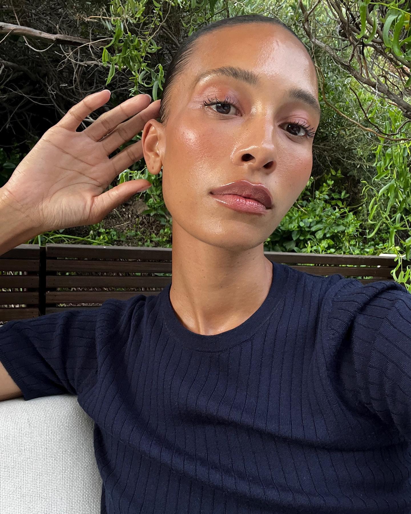 A woman taking a selfie with glowing skin