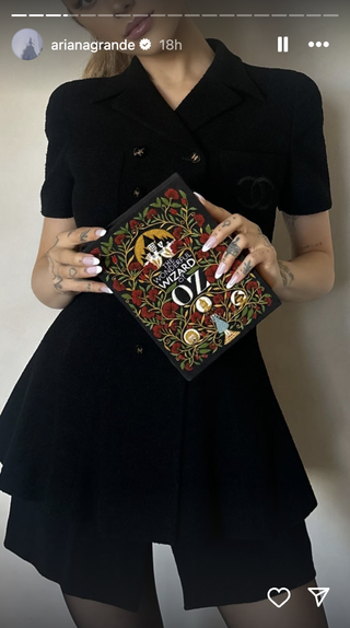 ariana grande wears a black chanel mini dress and a wizard of oz book clutch