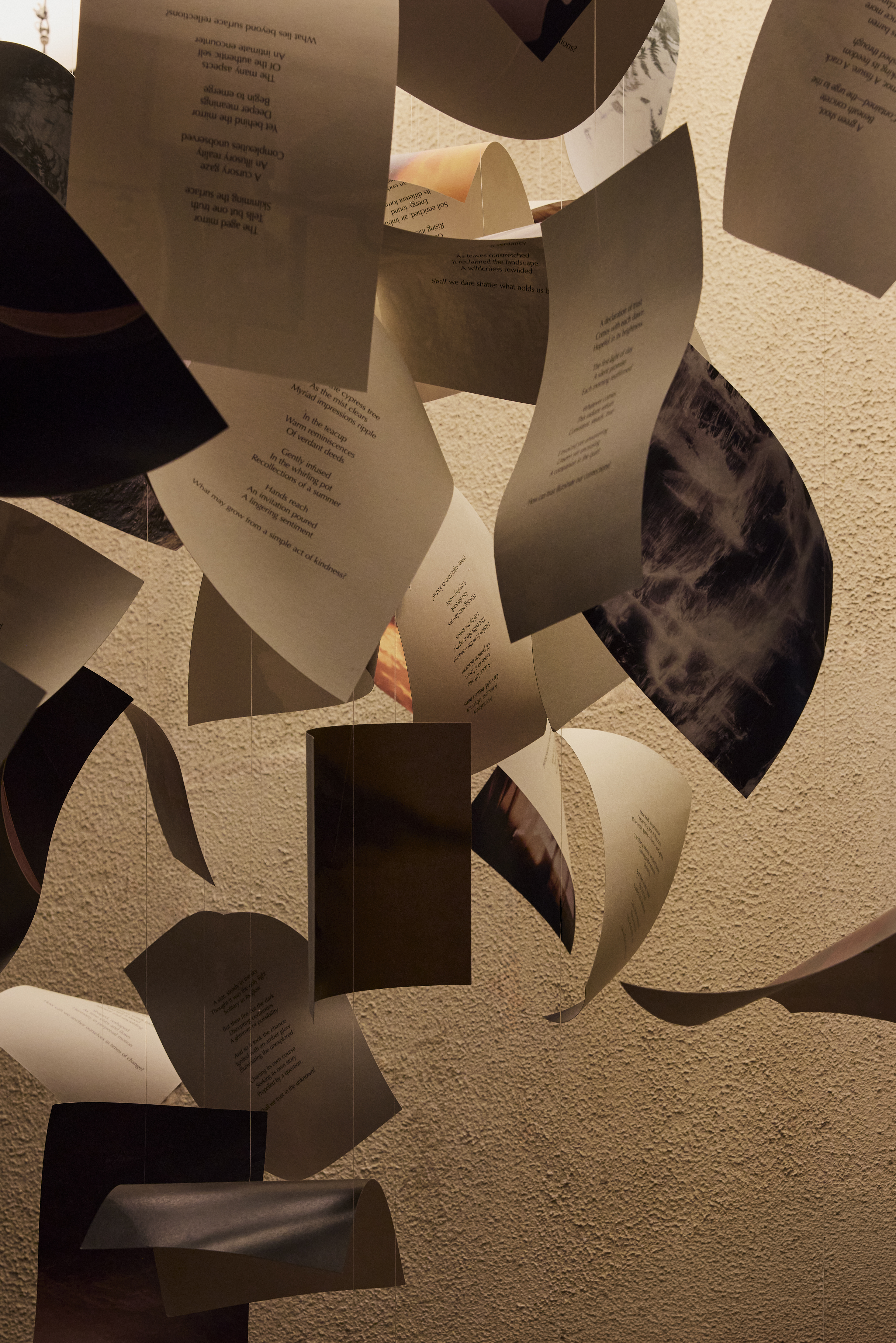 Interiors of a dimly lit, futuristically designed fragrance store with an illuminated roof, chocolatey interiors, and plenty of books and paper installations styled sophisticatedly.