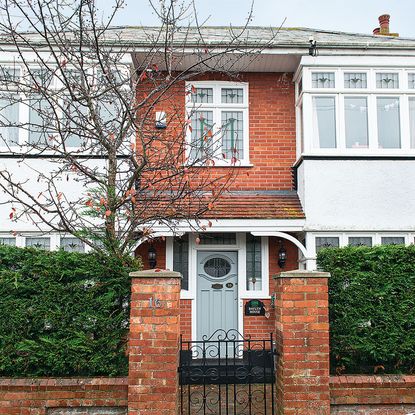 house with brick wall and tree 