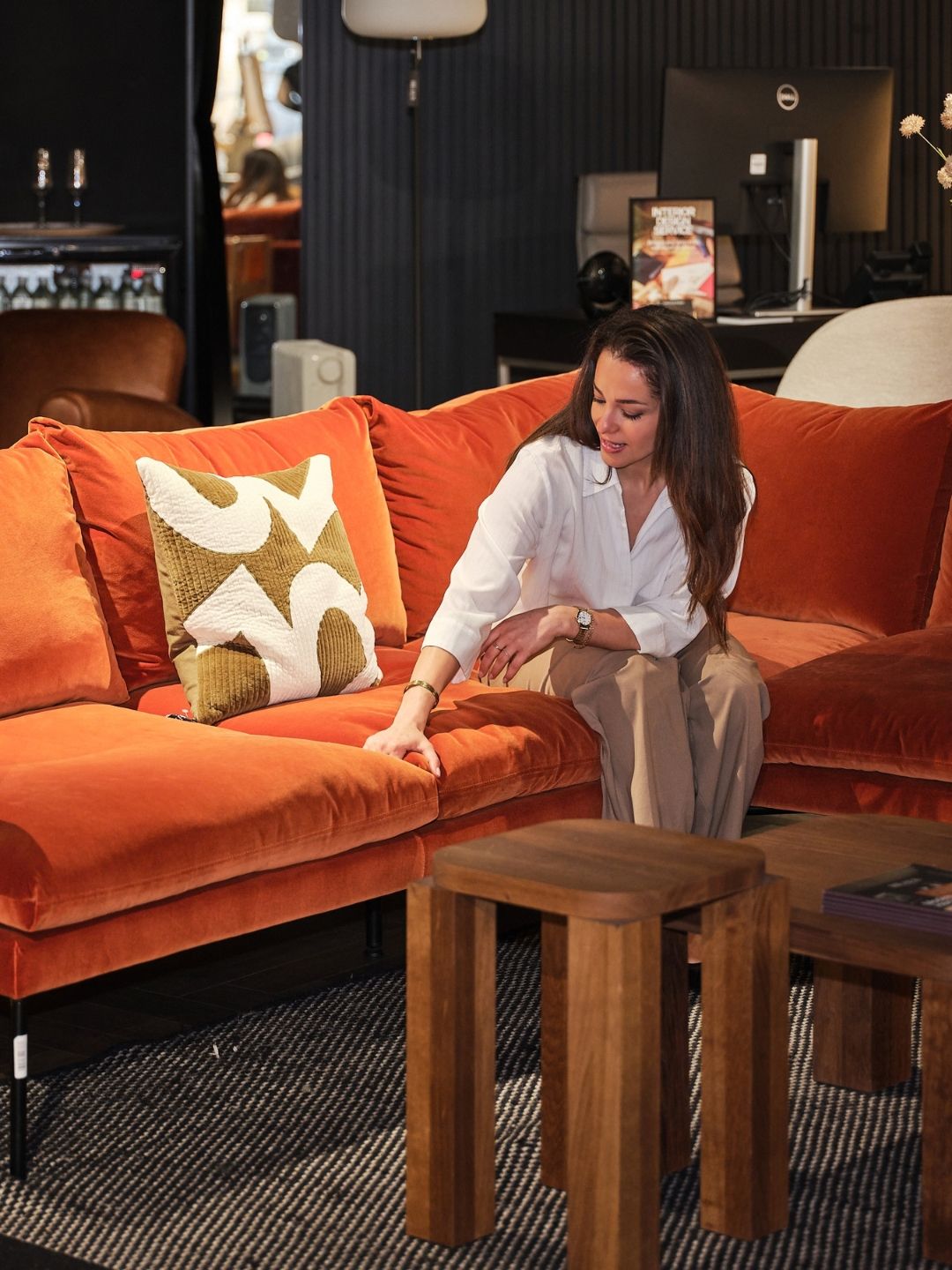 Testing Heal&rsquo;s Matera sofa, pressing the deep seat cushion to assess its softness and support.