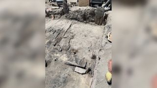 The excavation of the Chinese workers' home. Only floorboards and a few vertical posts are left behind. The boards used to construct the home were probably surplus railroad material, according to state archaeologists.