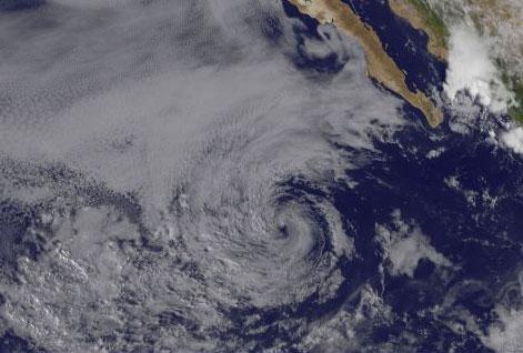 Visible imagery from the GOES-11 satellite at 1445 UTC (10:45 a.m. EDT) on July 11 shows the remnants of Calvin as a swirl of clouds in the eastern Pacific Ocean, several hundred miles off the western Mexico coastline.