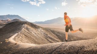 Runner on ridge of Ubehebe Crater, Death Valley National Park