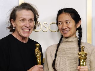 Frances McDormand and Chloe Zhao, winners of Best Picture for "Nomadland," pose in the press room at the Oscars on Sunday, April 25, 2021, at Union Station in Los Angeles