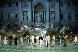 Models walk the runway at Fendi Roma 90 Years Anniversary fashion show at Fontana di Trevi