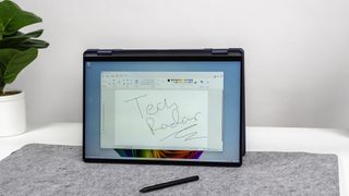 A Dell 16 Plus 2-in-1 in tent mode open to Microsoft Paint with TechRadar scribbled on a canvas