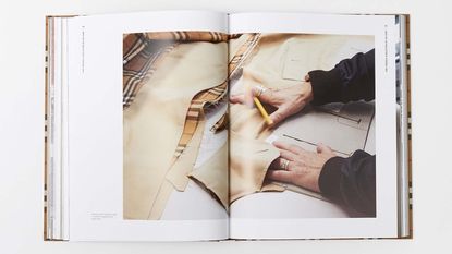Burberry fashion books spread with person on open page creating a trench coat