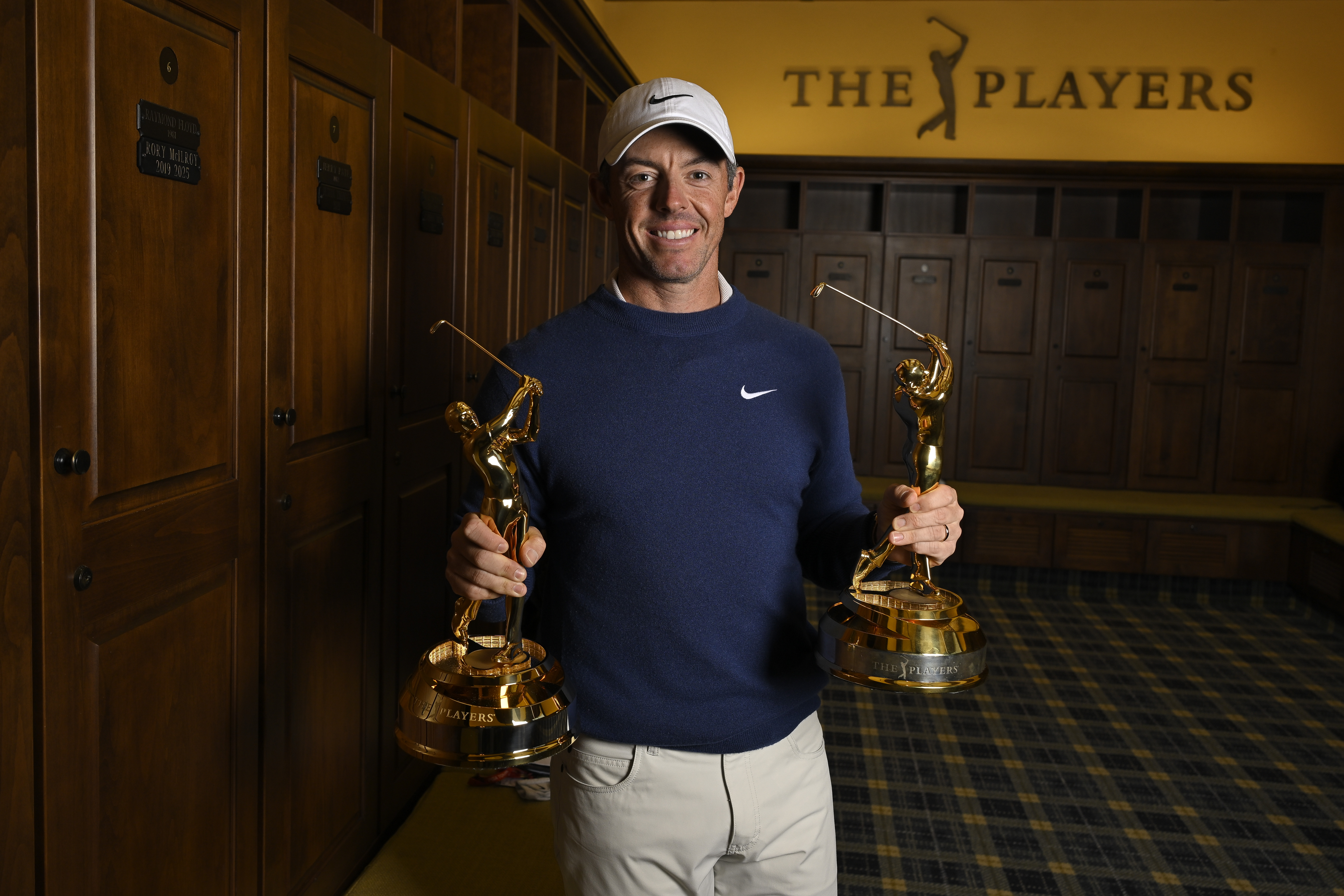 Rory McIlroy holds two Players Championship trophies
