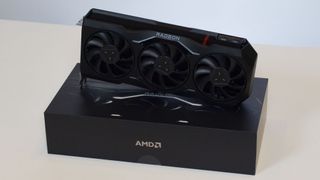 An AMD Radeon RX 7900 XTX on a table against a white backdrop